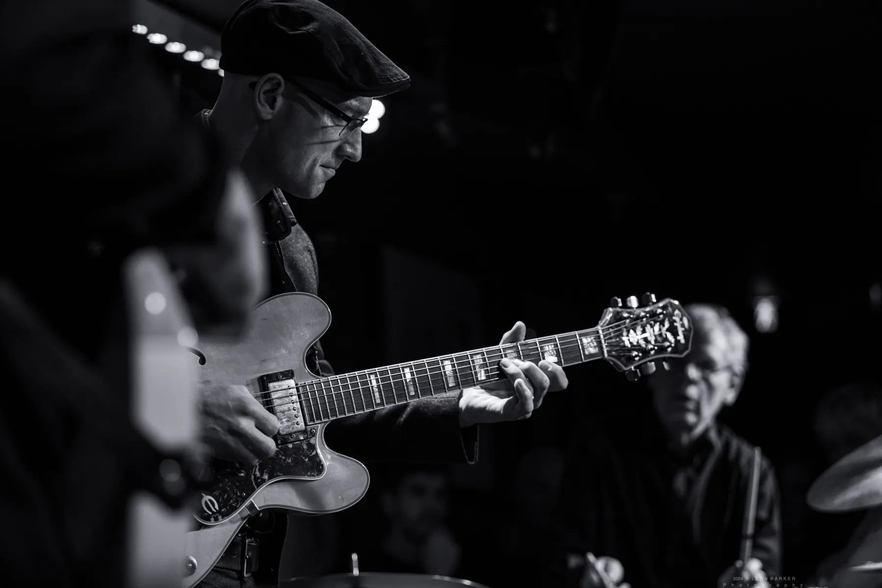 Pete Roth Trio musicians listening closely during a live performance.