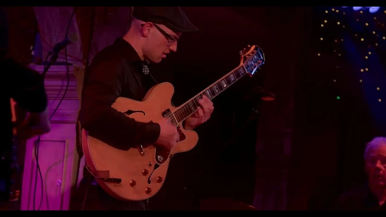 Pete Roth playing electric guitar in a Pete Roth Trio video.